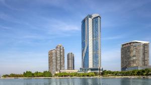 a city skyline with tall buildings and a lake at Renaissance Changzhou Wujin Hotel in Changzhou