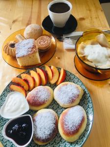 a table with a plate of pastries and a cup of coffee at At Nana's in Lagodekhi
