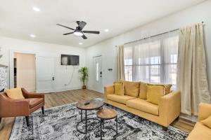 a living room with a couch and a ceiling fan at Pet-Friendly Wichita Home with Deck, Near Dtwn in Wichita