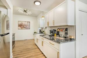 a kitchen with white cabinets and a counter top at Pet-Friendly Wichita Home with Deck, Near Dtwn in Wichita