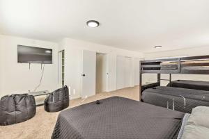 a bedroom with two bunk beds and a flat screen tv at Pet-Friendly Wichita Home with Deck, Near Dtwn in Wichita
