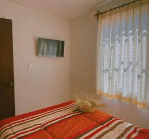 Ένα ή περισσότερα κρεβάτια σε δωμάτιο στο Casa Amapolas Oaxaca