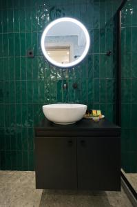 a bathroom with a sink and a mirror at Plane Tree Luxury Suites in Ioannina