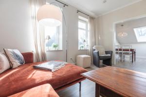 a living room with a couch and a table at Alte Wassermuehle Hollebek in Bredstedt