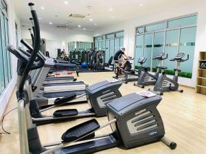 a gym with tread machines and a man in the background at High Floor studio Austin Regency Mount Austin w Balcony 3 plus 1pax 5 mins AEON in Johor Bahru