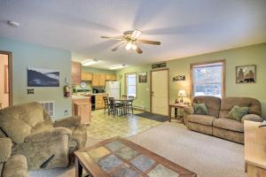 a living room with two couches and a ceiling fan at Wooded Danbury Cabin with Grill and Fire Pit! in Danbury