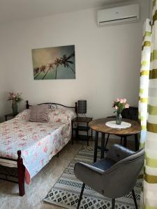 a bedroom with a bed and a table and a chair at Leyla in Vodice