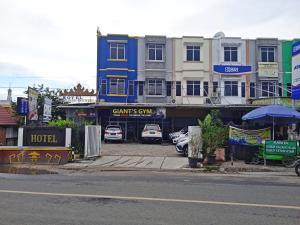 a building with cars parked in a parking lot at Hotel Bambu Kuning in Bandar Lampung