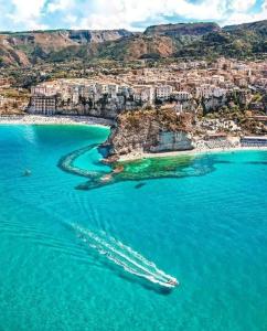 an aerial view of a beach with boats in the water at BlueMind in Tropea
