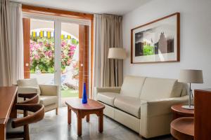 a living room with a couch and a table at Parque Santiago III Official in Playa de las Americas