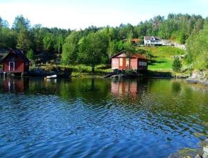 EikefjordにあるHoltarheim, holidayhouse, boat includedの横に家を置いた水