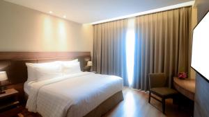 Un pat sau paturi într-o cameră la The Excelton Hotel