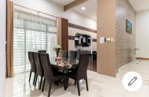 a dining room with a table and black chairs at FRA Homestay in Kuantan