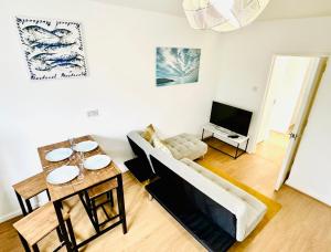 a living room with a couch and a table at Beautiful 3-Bed Apartment with Driveway Parking in Nottingham