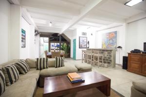 a living room with a couch and a coffee table at Hikks Villa in Hikkaduwa