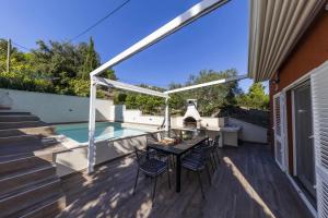 a patio with a table and chairs and a swimming pool at Villa Karmen Adriatica in Kukljica +34 photos