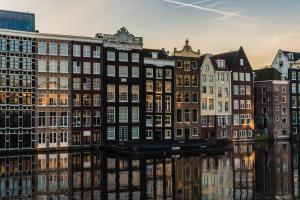 een groep gebouwen naast een rivier bij Hotel Bloemendaal in Bloemendaal