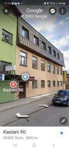 a car parked in front of a building at Kastani Factory Apartments in Tartu