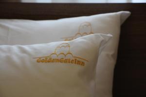 a white pillow with a black and white pattern on it at Golden Gate Inn in Kyiv