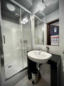 a bathroom with a sink and a shower at Hotel Szyndzielnia Eco in Bielsko-Biała +25 photos