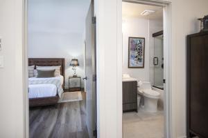a bedroom with a bed and a bathroom with a toilet at Townsend Place B202 Condo in Beaver Creek +21 photos