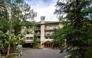 an exterior view of a building with trees at Townsend Place B202 Condo in Beaver Creek
