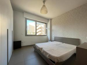 a bedroom with a bed and a window at Sebeto Apartment in Naples