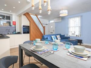 a dining room and kitchen with a table and chairs at Rock and Reel in Dartmouth