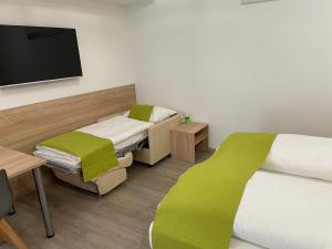 Postel nebo postele na pokoji v ubytování Hotel Garni Ilys Inn