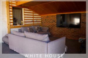 a living room with a couch and a tv at White House in Tbilisi City