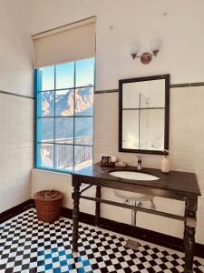 a bathroom with a sink and a window at Faraway Cottages, Auli in Joshīmath