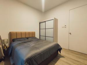 a bedroom with a large bed and a closet at Banana Homestay Kuching - P' Residence in Kuching