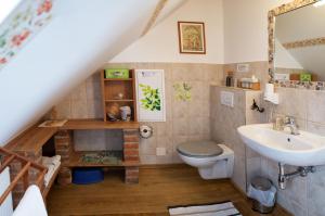a bathroom with a toilet and a sink at FerienAppartments Landhaus FühlDichWohl in Fehring +98 photos