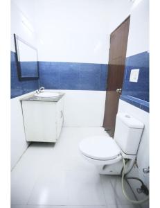 a bathroom with a toilet and a sink at Hotel Kolam, Dehradun in Dehradun