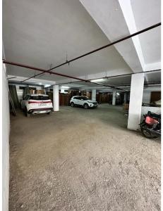 a garage with two cars parked in it at Hotel Kolam, Dehradun in Dehradun