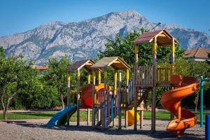 a playground with a bunch of slides in a park at Agva Apart Otel in Kemer