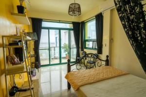 a bedroom with a bed and a large window at Meet Bay B&B in Xiyu