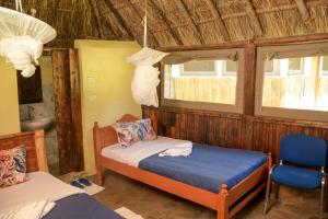 Säng eller sängar i ett rum på Giraffe Hills Mara Camp
