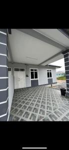 a large white house with a large patio at Casa Harmony in Tanah Merah