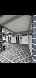 a large open garage with a bench in front of a house at Casa Harmony in Tanah Merah