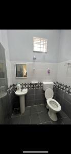 a bathroom with a toilet and a sink at Casa Harmony in Tanah Merah