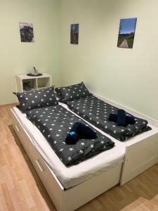 a bed with a black comforter with stars on it at Ferienwohnung Rüth in Kall