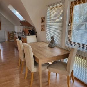 a dining room with a wooden table and chairs at Ferienwohnung MaLu in Aich