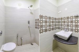 a bathroom with a toilet and a sink at FabHotel Harmony in Colonelganj +18 photos