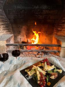 a table with a plate of food and two glasses of wine at Guyers House Hotel and Restaurant in Corsham