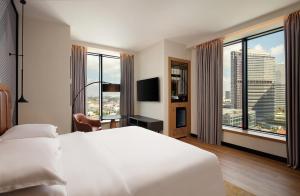 a hotel room with a white bed and a large window at Sheraton Istanbul Esenyurt in Istanbul