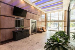 a lobby with a flat screen tv on a wall at Bourbon Street Bliss in New Orleans