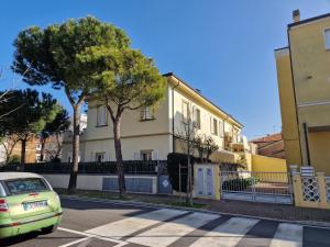 a car parked in a parking lot in front of a building at Villa Sante Residence in Pesaro