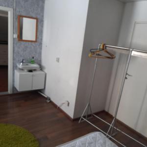 a bathroom with a sink and a stand up shower at Omakotitalo ykspihlajassa 110m2 in Kokkola