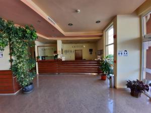 a lobby of a hospital with potted plants at Hotel Veris in Sunny Beach